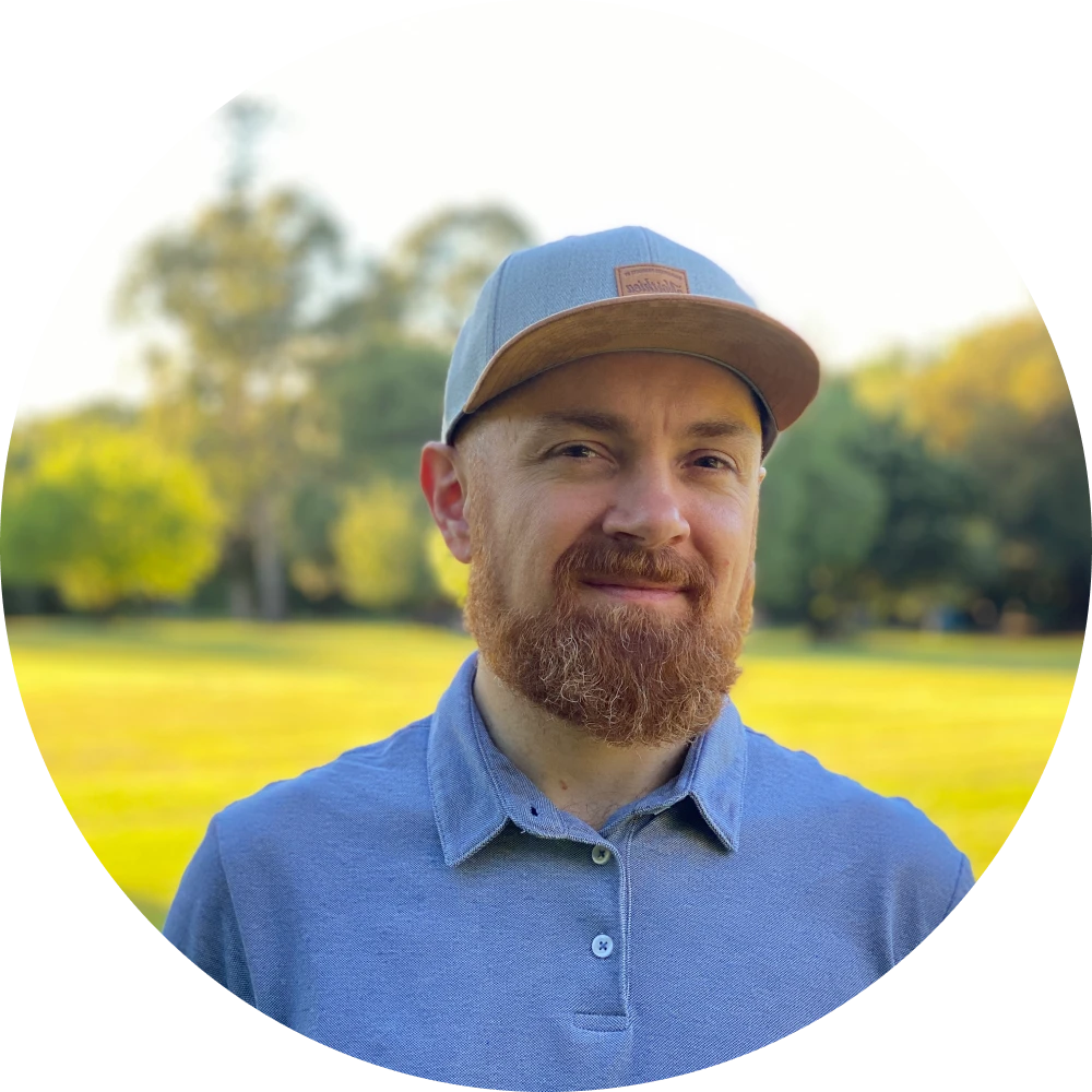 Damian Demasi with a hat in a park on a sunny day.